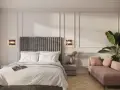 Elegancka sypialnia z łóżkiem, różową sofą i rośliną.