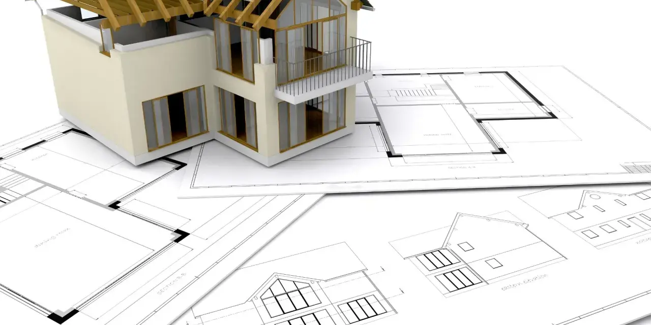 Model domu na planach architektonicznych. Zastanawiasz się, ile trwa budowa domu? To zależy od wielu czynników, ale zaczyna się od projektu.