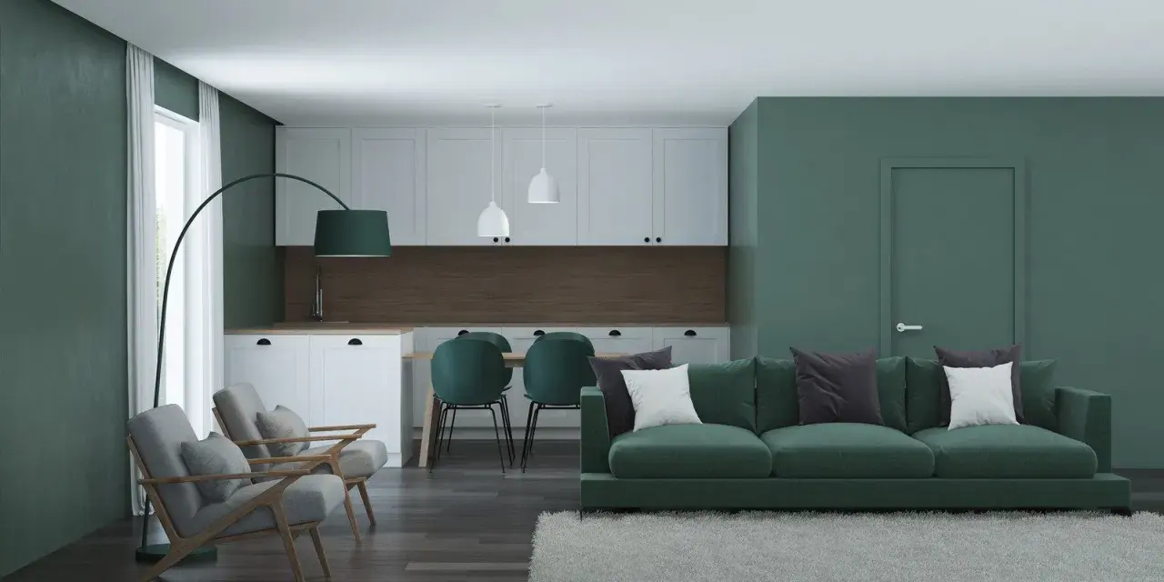 Nowoczesny salon z kuchnią w odcieniach zieleni. Seledynowy kolor ścian i mebli tworzy spokojną atmosferę.