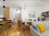 Drewniana podłoga w jodełkę, meble w kolorze tik, okrągły stół z szarymi krzesłami i kanapa z poduszkami.