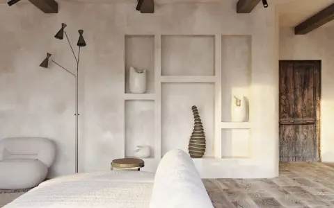 Wnętrze w stylu wabi sabi: surowe tynki, drewniane belki, rustykalne drzwi i minimalistyczne dekoracje tworzą spokojną atmosferę.