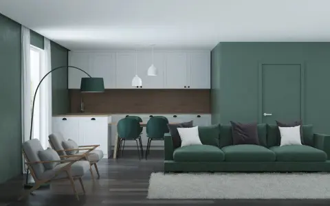 Nowoczesny salon z kuchnią w odcieniach zieleni. Seledynowy kolor ścian i mebli tworzy spokojną atmosferę.