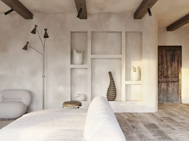 Wnętrze w stylu wabi sabi: surowe tynki, drewniane belki, rustykalne drzwi i minimalistyczne dekoracje tworzą spokojną atmosferę.