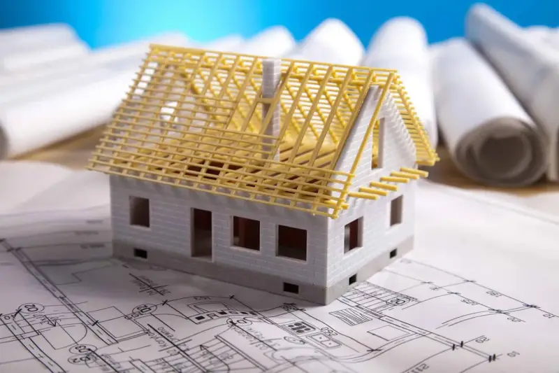 Model domu na planach architektonicznych. Zastanawiasz się, ile kosztuje adaptacja projektu?